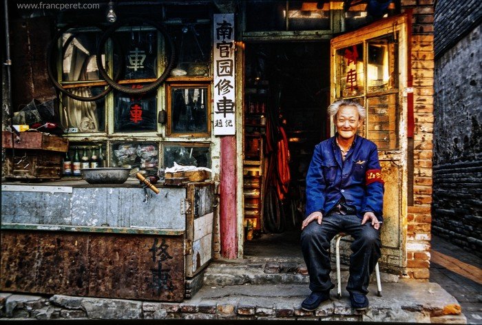 Traditional Beijing Convenient store and bicycle repair shop with its happy owner. Last smile before destruction.